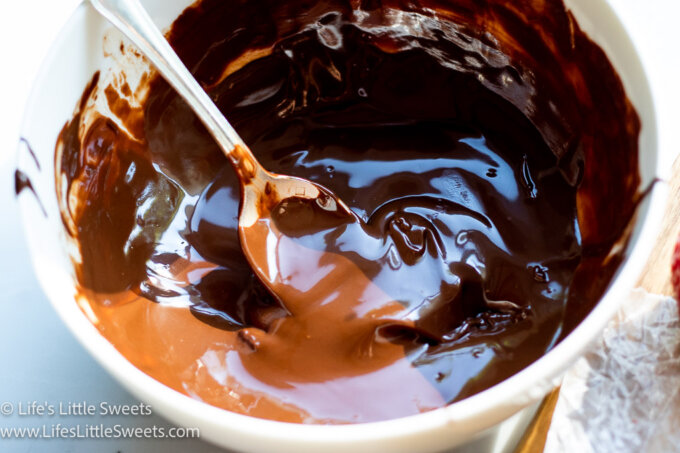 a bowl of melted chocolate with a spoon