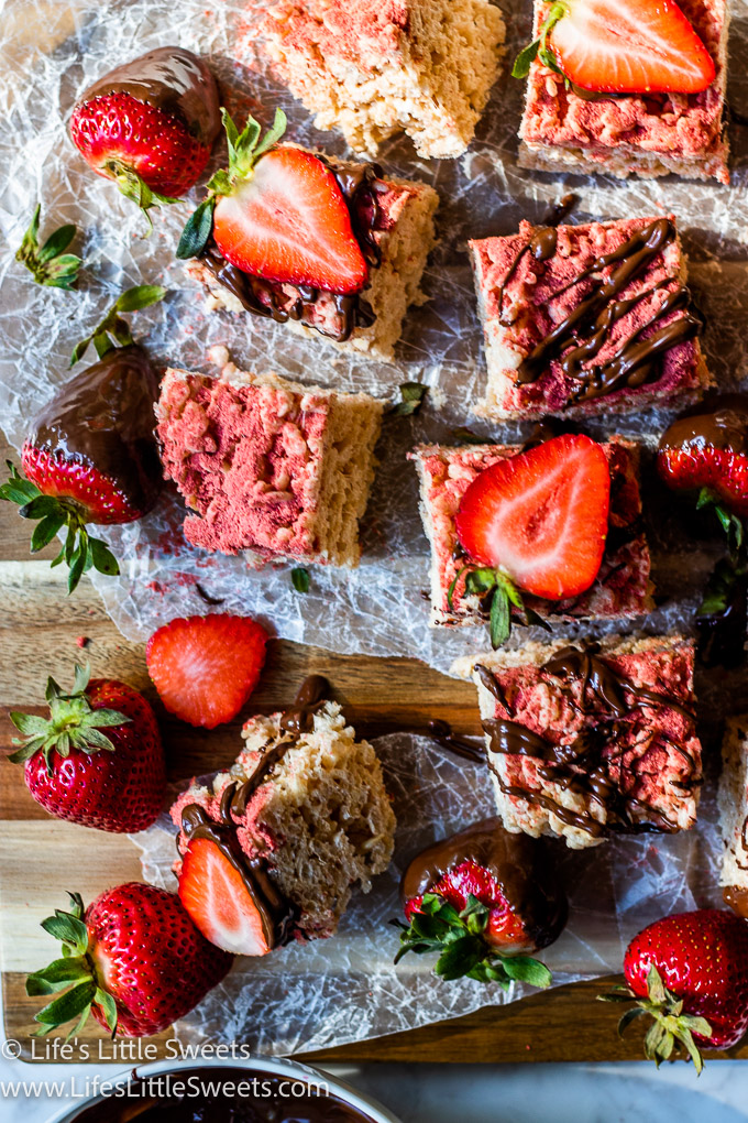 Strawberry Rice Krispie Treats cut into squares with strawberries