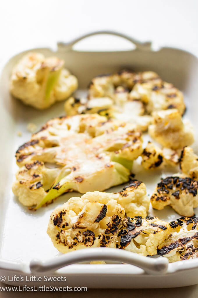 cooked, grilled cauliflower in a white, large serving platter
