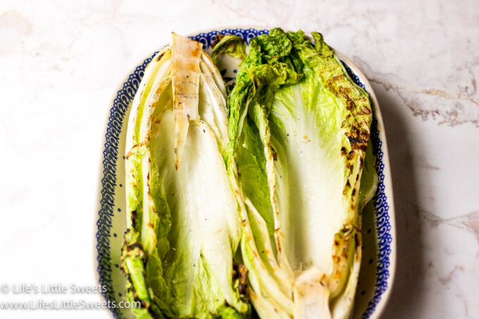 cooked Napa cabbage on an oval serving plate over a white marble table