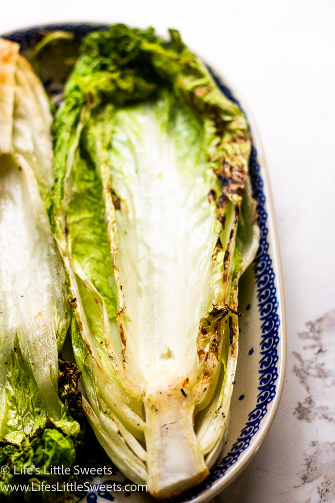 a close photo showing a view of cooked, grilled green Napa cabbage in an oval serving platter