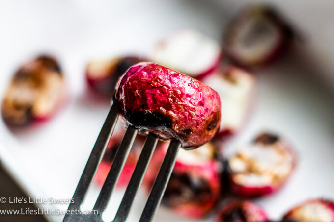 a round red grilled radish on a fork