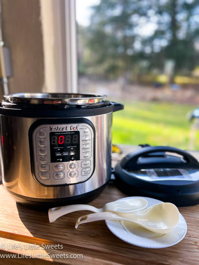 an Instant Pot on a wood table in front of a window