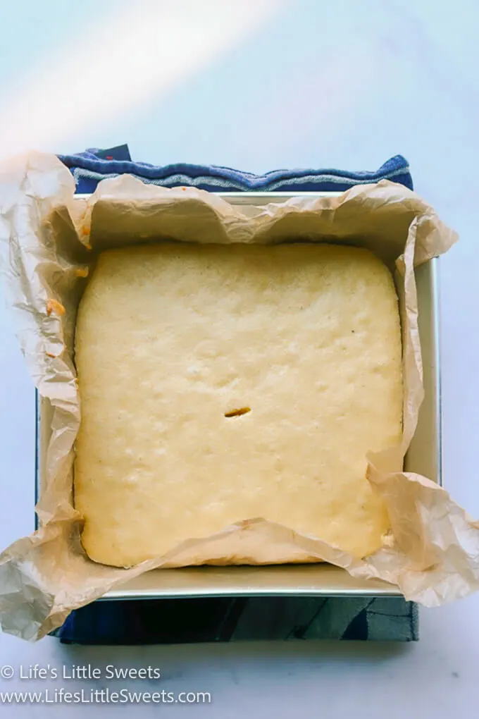 a vertical photo of cornbread in a square pan