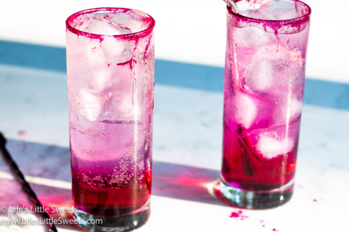 2 cold pink drinks on a marble table