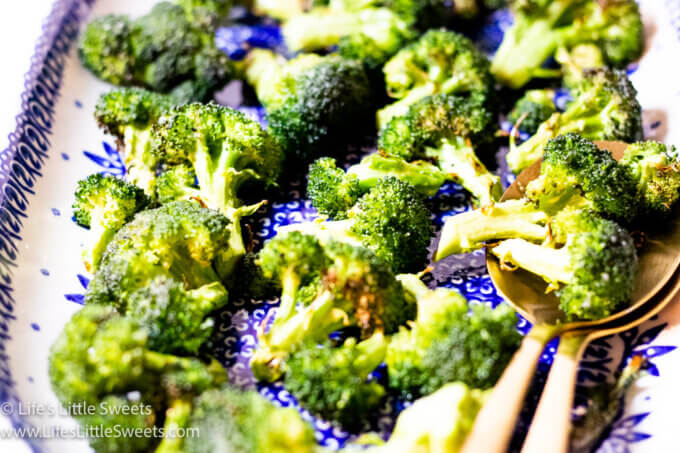 cooked broccoli on a plate with spoons