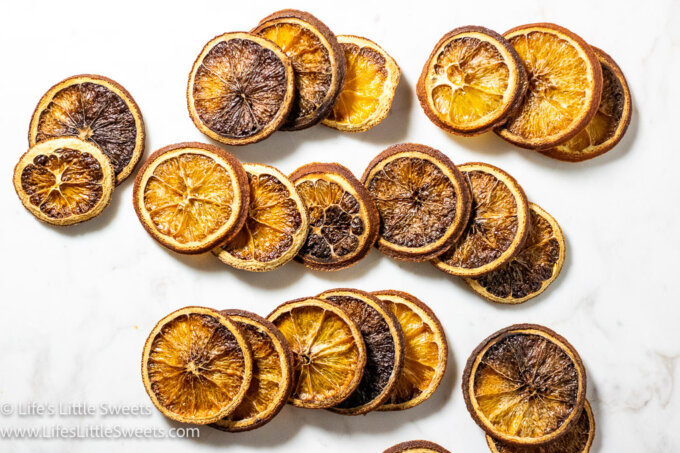 rows of dried orange slices together over a white marble surface