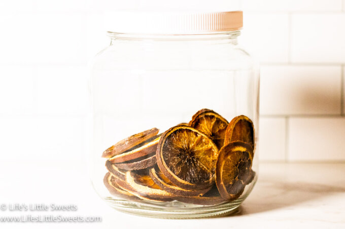 dehydrated orange slices in a jar with a white lid