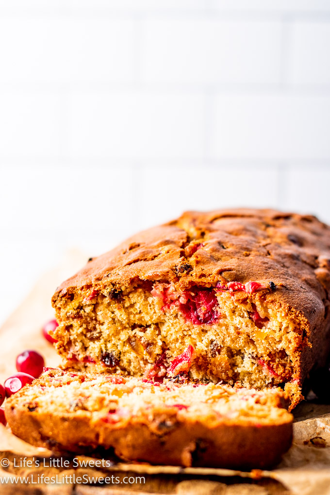 a close up of cranberry orange bread sliced with a white background