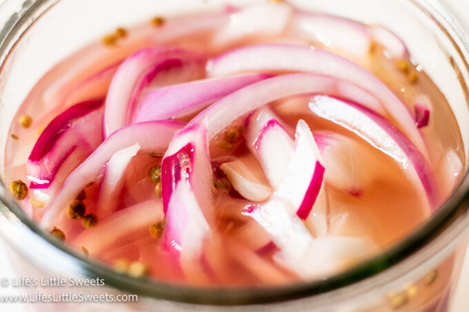 red onions in liquid with pickling spices