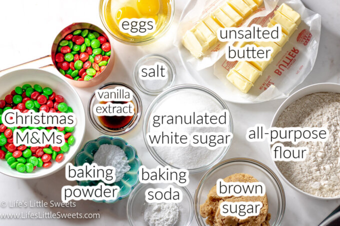 a photo diagram of various ingredients for Christmas M&M Cookies with the names of the ingredients over the top of each ingredient