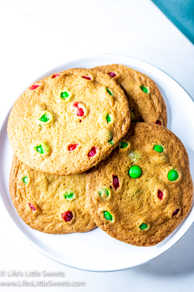 a close up of a M&M cookie on a white plate