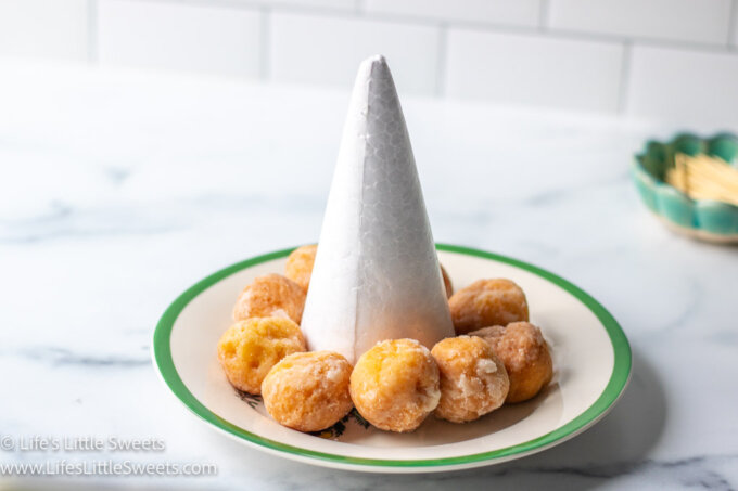 donut holes around a white styrofoam cone
