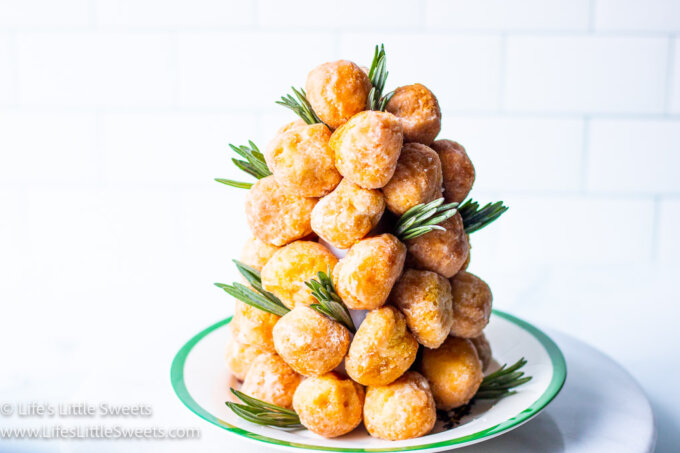 donut holes around a white styrofoam cone with green sprigs in a white kitchen