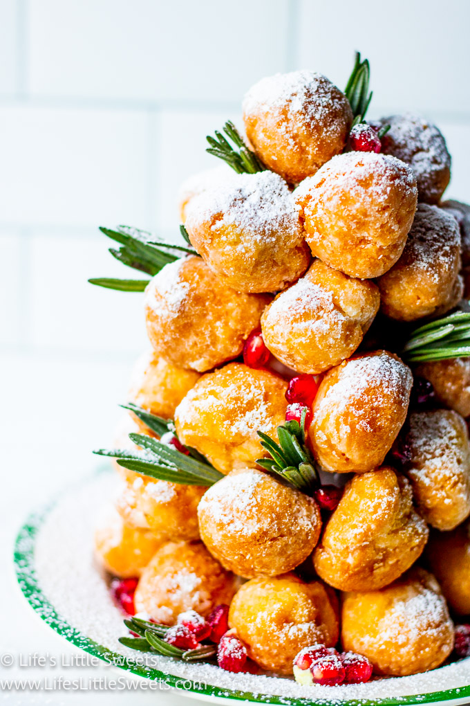 a donut tree with fresh lavender sprigs with pomegranate arils with powdered sugar