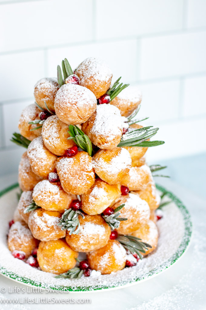 a donut tree with fresh lavender sprigs with pomegranate arils with powdered sugar