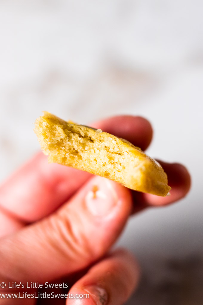 a bite of a sugar cookies being held