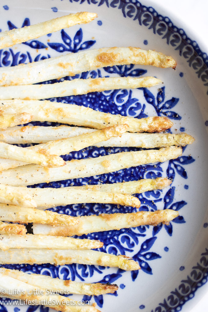 cooked white asparagus on a blue and white plate