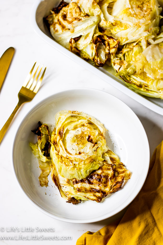 Cabbage Steaks on a white plate with a gold fork