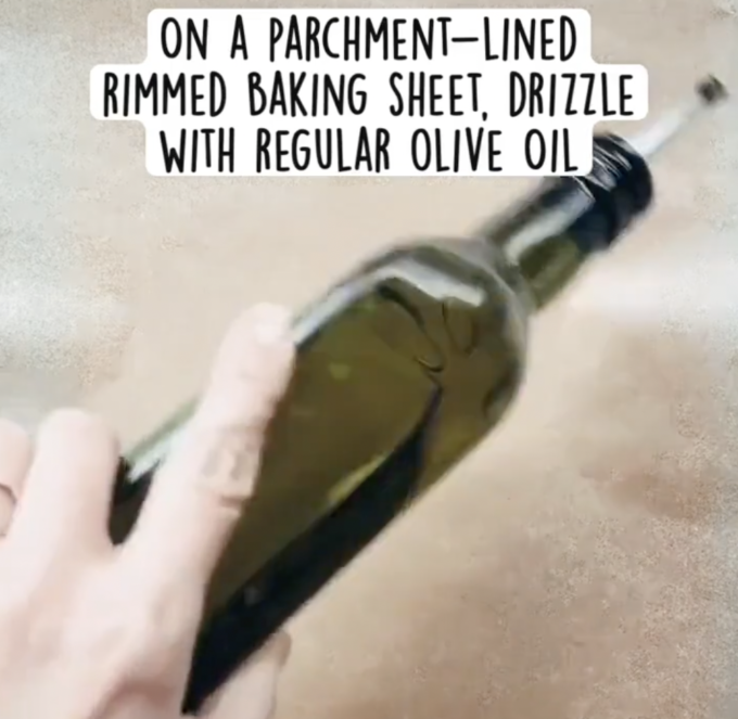 prepping a rimmed baking sheet with olive oil