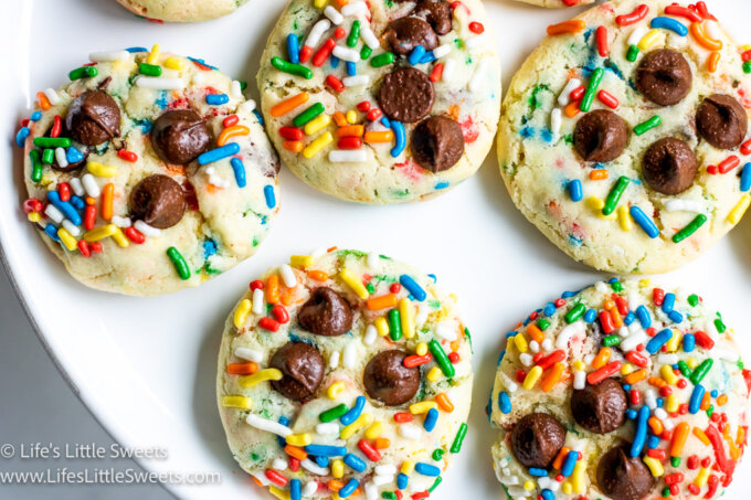 colorful sugar cookies with sprinkles and chocolate chips on top
