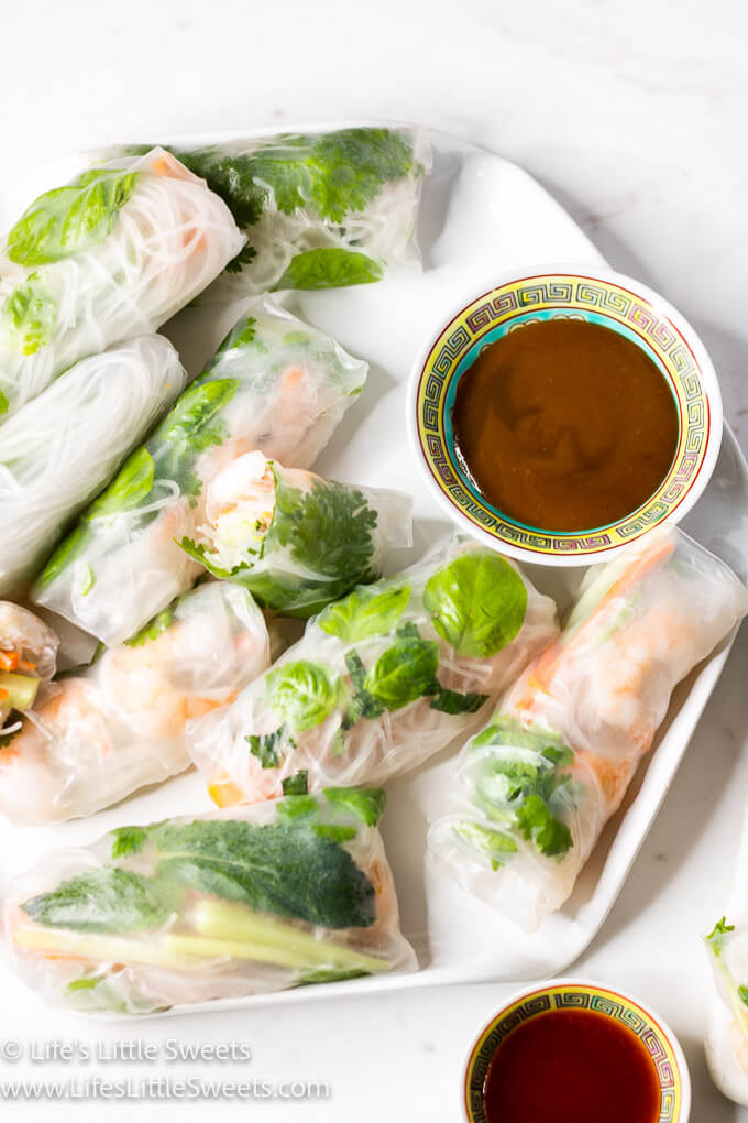 fresh spring rolls on a white plate with sauces