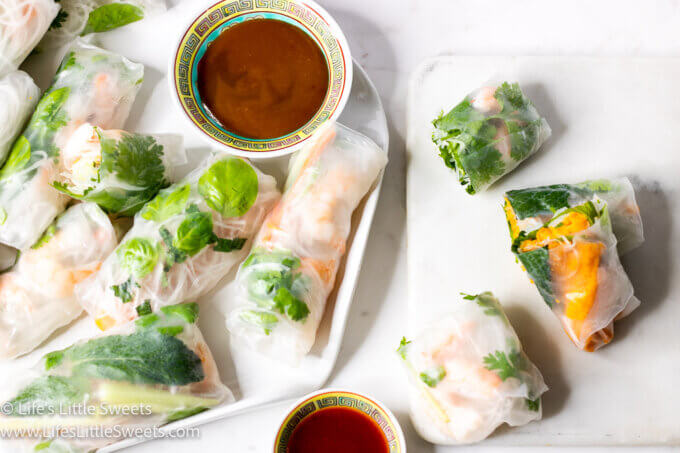 Asian fresh spring rolls on a white plate with sauces
