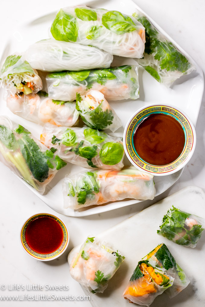 a fresh spring roll spread with sauces on a white marble surface