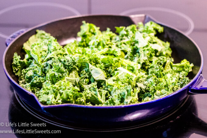 kale cooking in a cast iron skillet