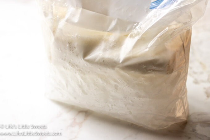 vanilla ice cream being made in a double bag with ice on a marble surface