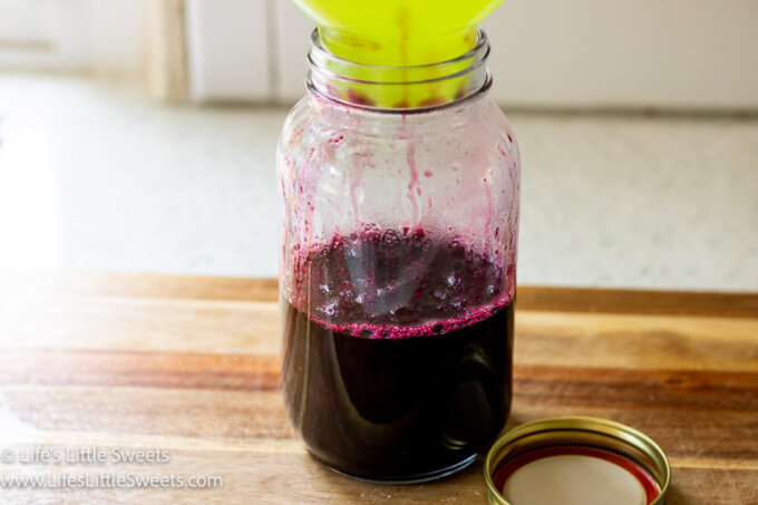 blueberry syrup in a mason jar on a counter