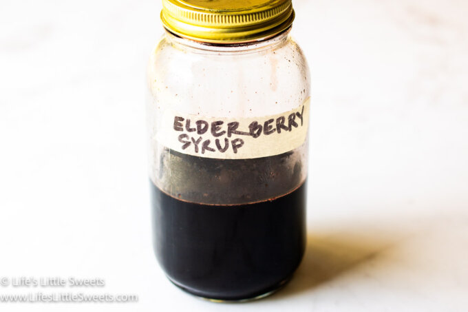 Elderberry Syrup in a mason jar with a white background