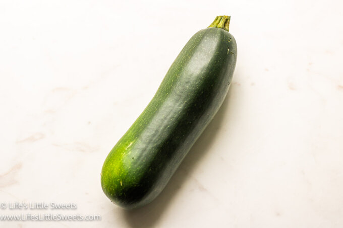 a zucchini on a marble table