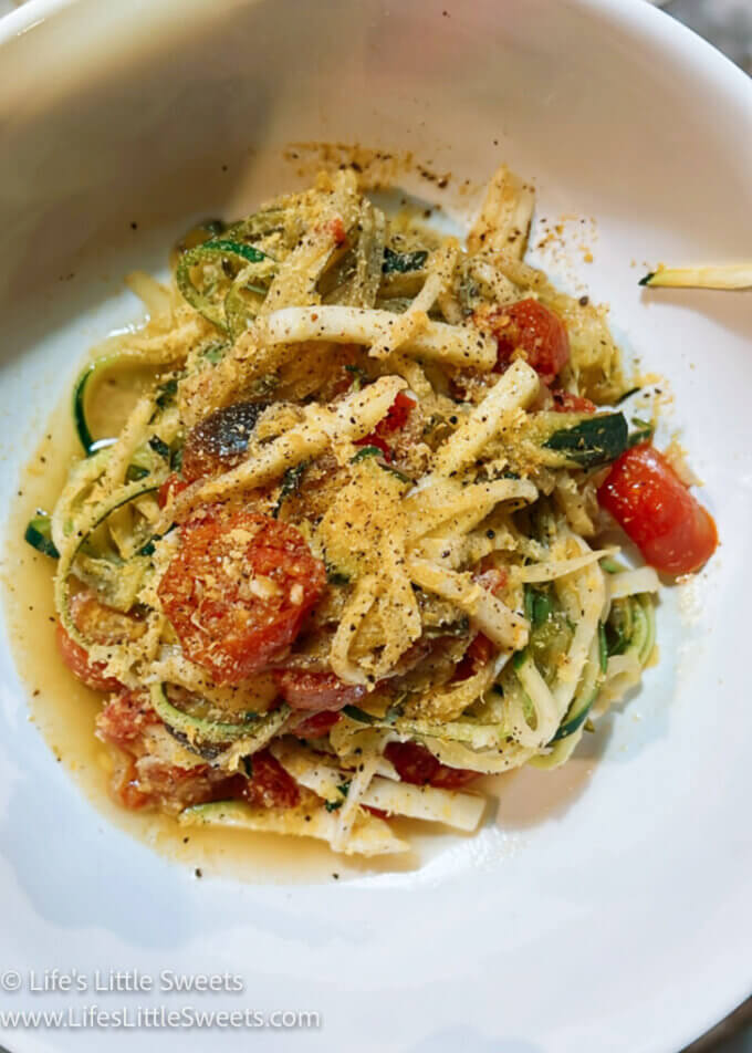 Zucchini Noodles with tomatoes in a white bowl