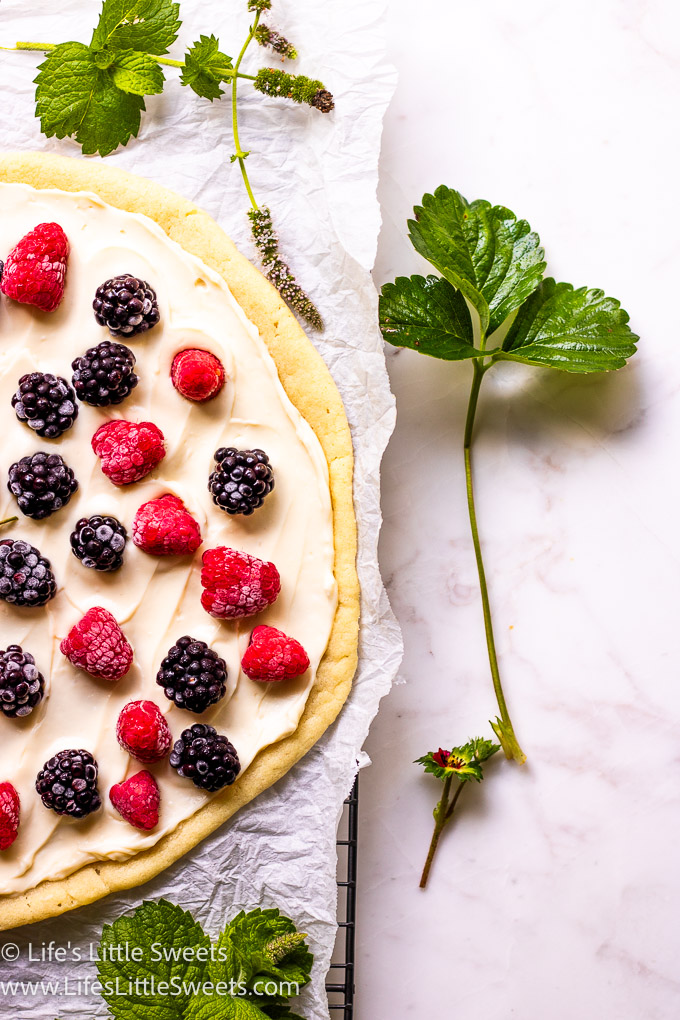 fruit pizza with fresh berries on top with strawberries
