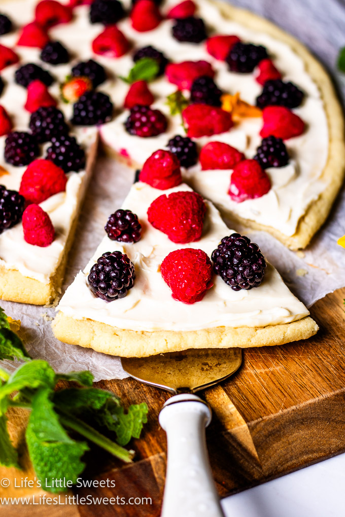 a cut slice pf fruit pizza with fresh berries on top