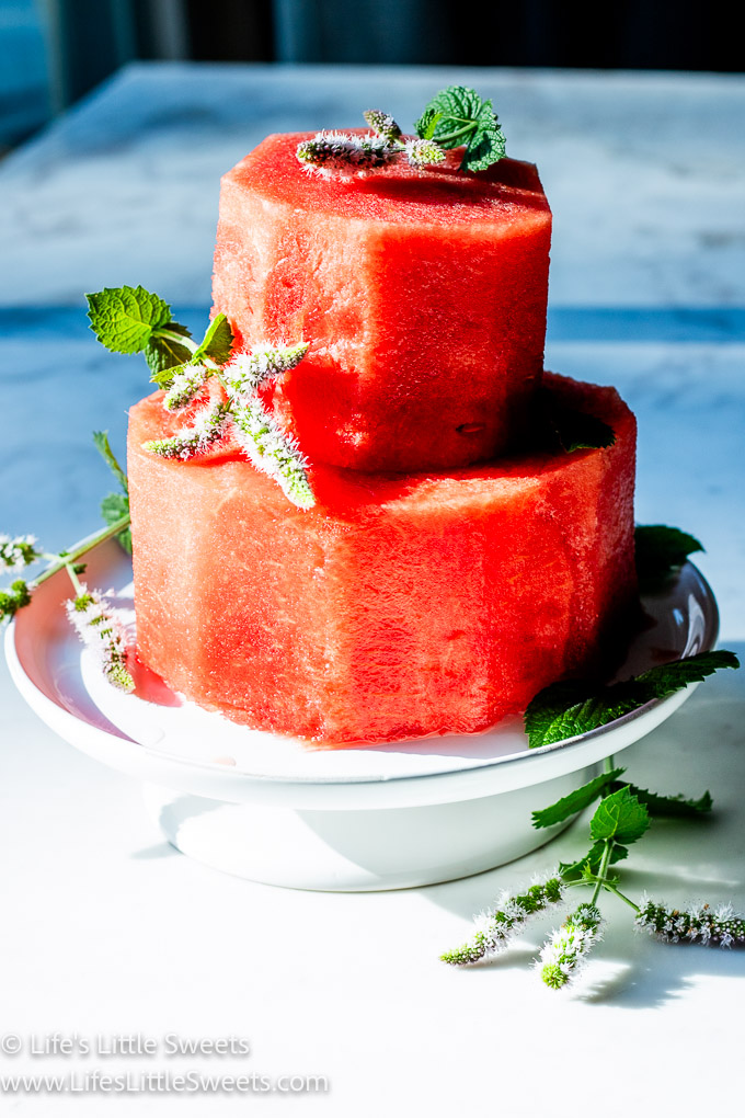 a red watermelon cake with flowering herbs