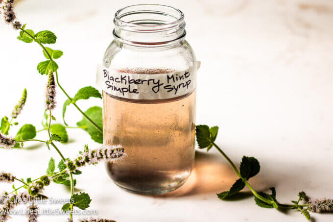 light purple simple syrup with flowering apple mint