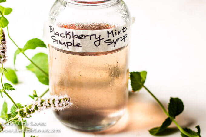light purple simple syrup with a white background and flowering mint 