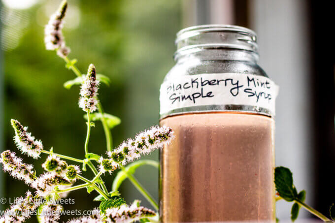 fresh flowering mint with a purple simple syrup in a mason jar