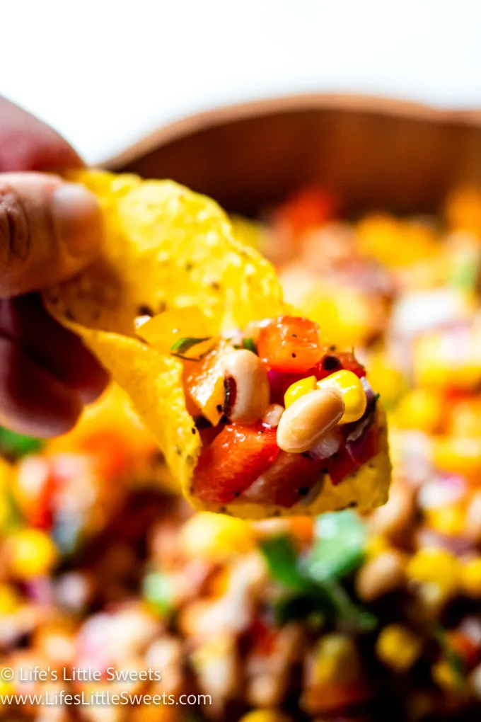 a yellow tortilla chip with Cowboy Caviar Recipe on it