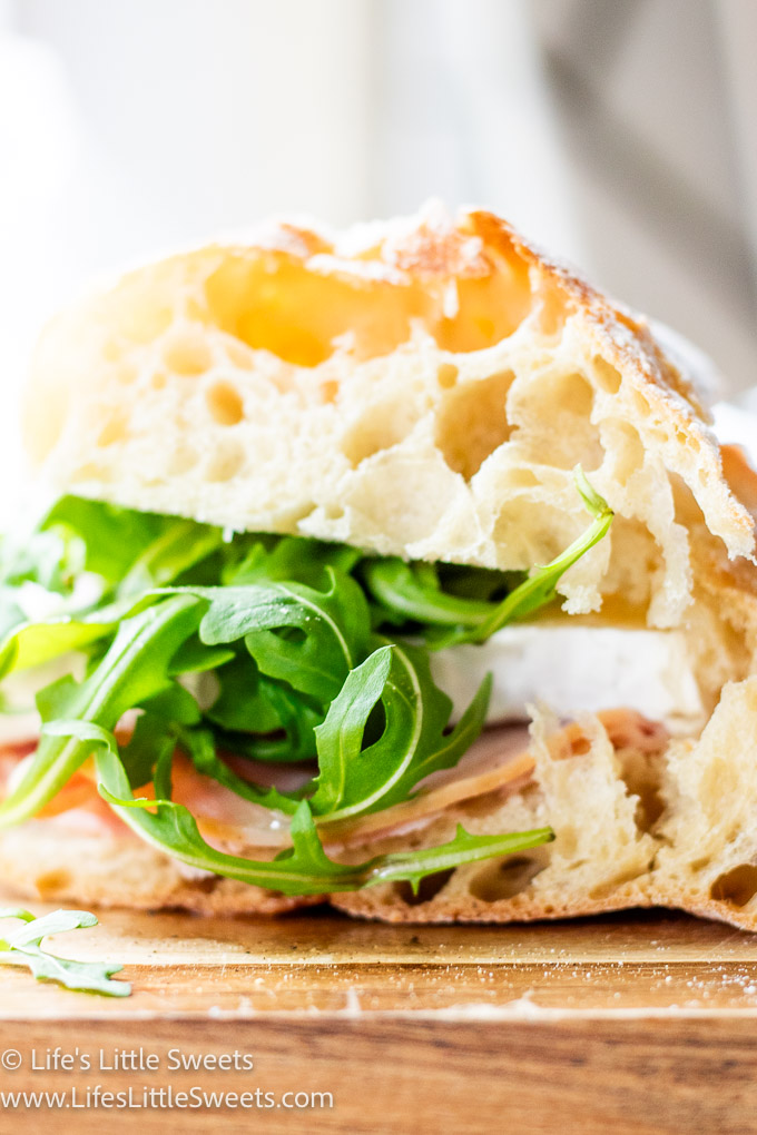Ham Brie Arugula Sandwich with a white background