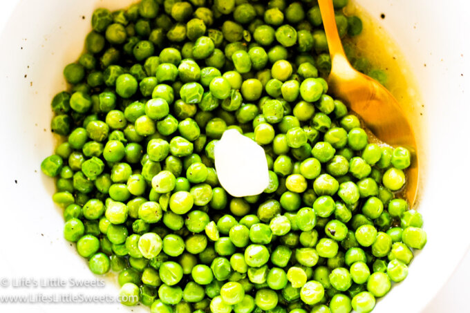 Slow Cooker Crock Pot Butter Green Peas in a white bowl with a gold spoon