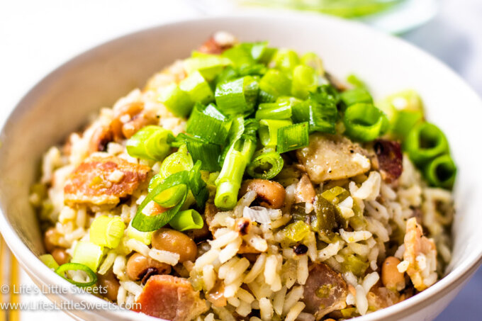 a bowl of rice and beans with green onions