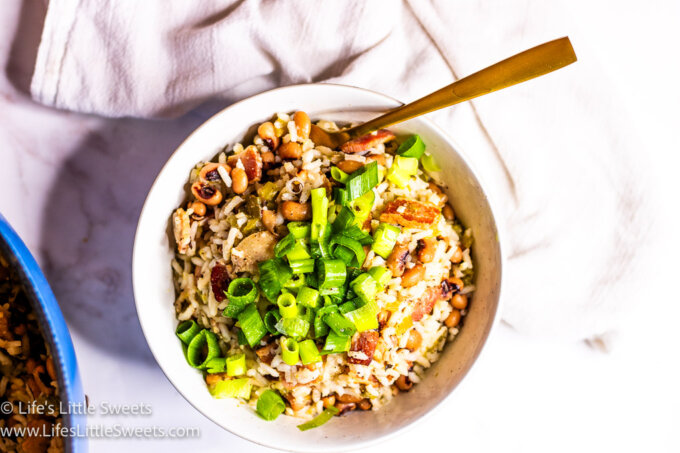 Hoppin' John recipe in a white bowl with a gold fork