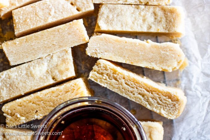 Maple Shortbread Cookies cut into bars served with a bowl of maple syrup