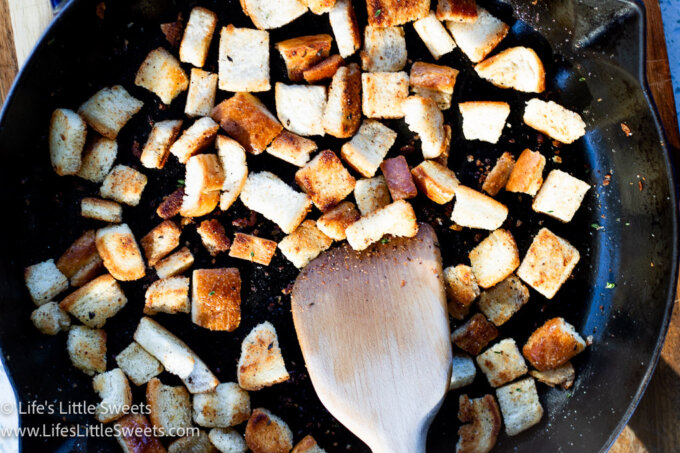croutons in a pan with a wooden spatula