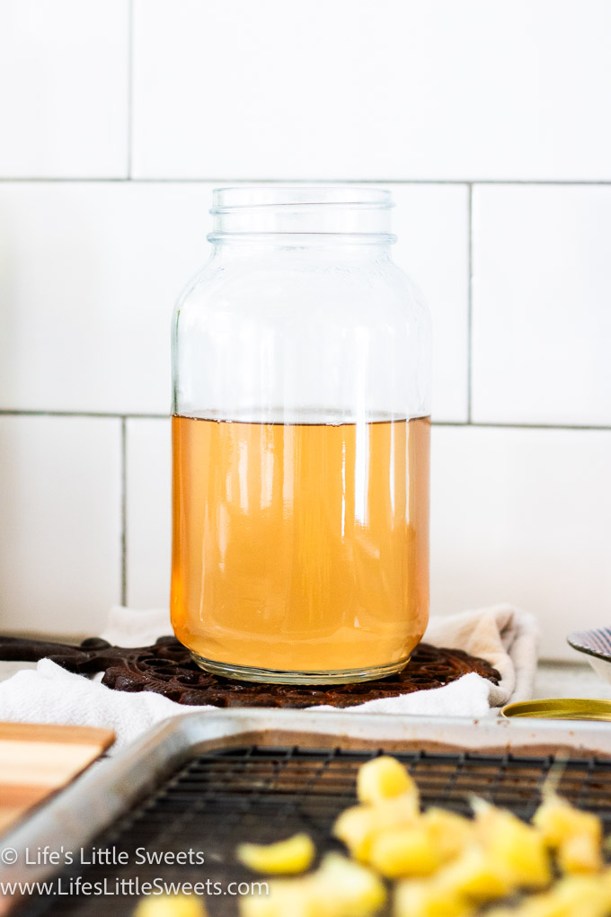 a glass mason jar filled with freshly made ginger syrup