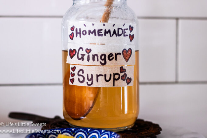 ginger syrup in a jar with a wooden spoon