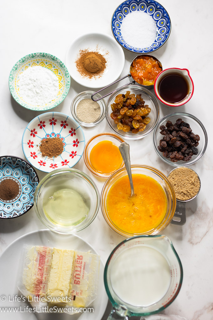 ingredients for hot cross buns on a marble table